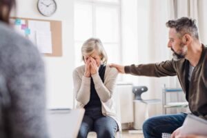 a-senior-depressed-woman-crying-during-group-thera-HSU85RB-scaled.jpg